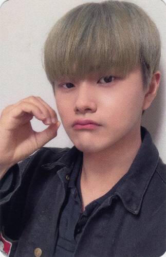Photocard of Jahan wearing a black shirt and making an "o" with his hand while slightly pouting