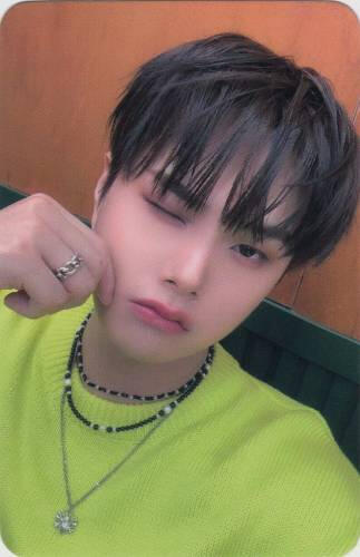 Photocard of Jahan wearing a green sweater while winking and pinching his cheek