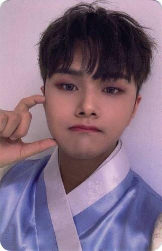 Photocard of Jahan in a blue hanbok making a cheek heart