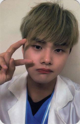 Photocard of Jahan wearing a white jacket over a blue shirt, making a peace sign