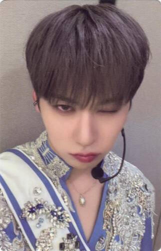 Photocard of Keonhee wearing an intricate blue and silver outfit and staring up at the camera with one eye closed