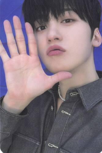 Photocard of Keonhee wearing a grey denim button up looking into the camera, holding an open palm by his face