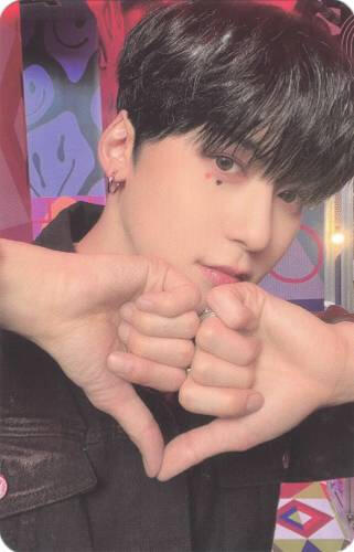 Photocard of Keonhee making a heart with two fists and his thumbs pointed down