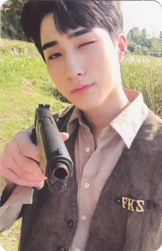 Photocard of Harin pointing a gun at the camera