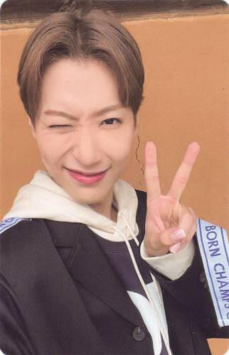 Photocard of Dongmyeong winking and making a peace sign