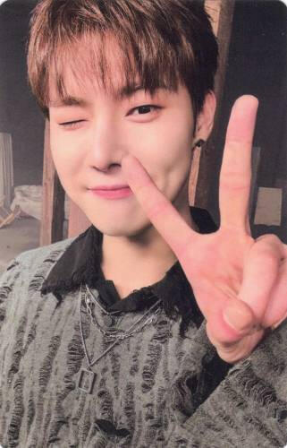 Photocard of Yonghoon wearing a grey sweater, winking, and throwing up a peace sign