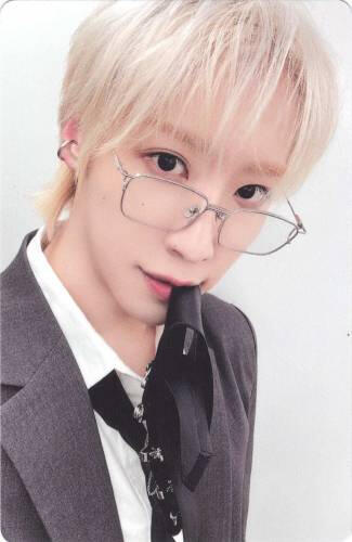 A photocard of Dongmyeong biting his tie