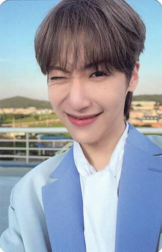 Photocard of Dongmyeong wearing a light blue suit and winking