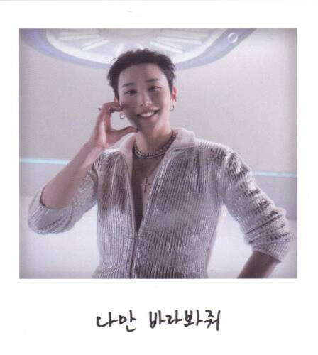 Fake polaroid of Moon Jongup wearing a silver shirt and making a half hand-heart on his cheek