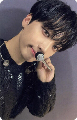 A photocard of Arthur wearing a torn black sweater and a face microphone while grinning