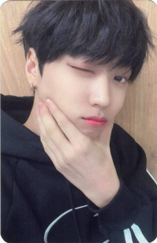 Photocard of Arthur pinching his cheeks and winking