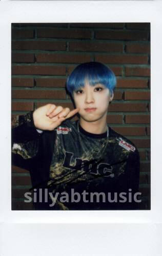 A polaroid of blue haired Arthur poking his cheek