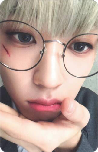 Photocard of Arthur closeup to the camera with a cut across his face