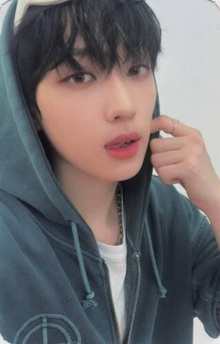 Photocard of Arthur wearing a green hoodie and sticking his tongue out