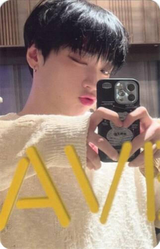 Photocard of Arthur taking a mirror selfie with his hands in a heart shape