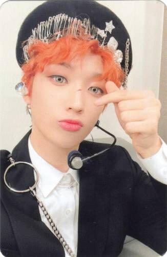 Photocard of Arthur with orange hair making a peace sign