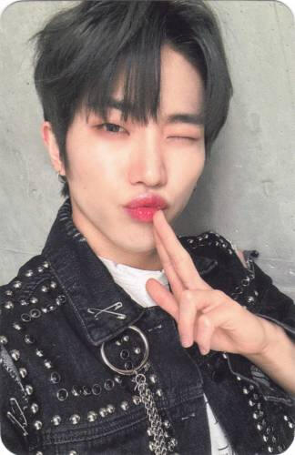 Photocard of Dann winking and blowing out a finger gun