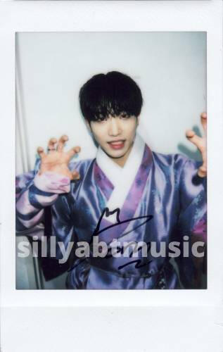 Polaroid of Dann making clawed hands in his purple ascension hanbok