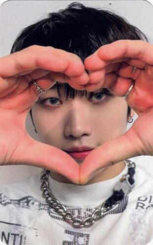 Photocard of Dann making a heart around his face
