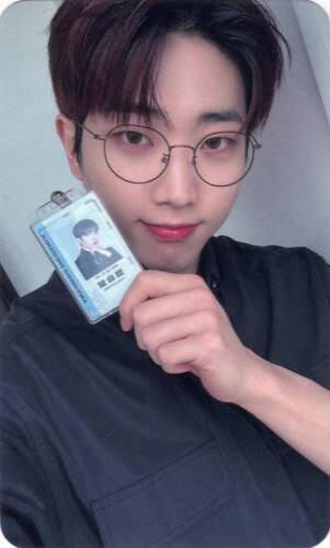 Photocard of Kingdom Company Dann holding up his badge