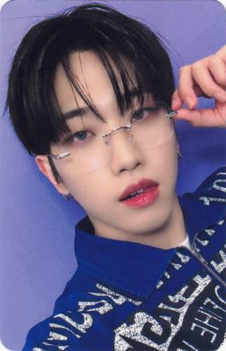 Photocard of Dann wearing glasses and lightly sticking his tongue out