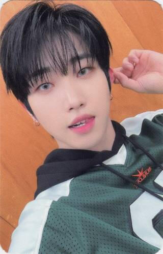 Photocard of Dann in a green jersey hoodie