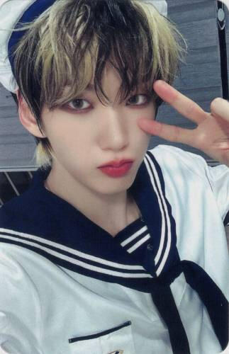 Photocard of Hwon wearing a sailors outfit and making a peace sign