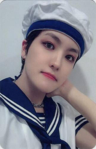 Photocard of Louis wearing a sailors outfit and holding his neck