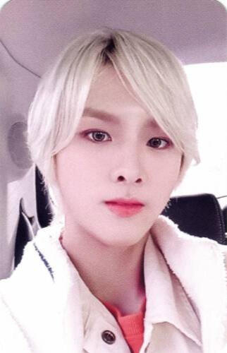 Photocard of Ivan with white hair staring at the camera