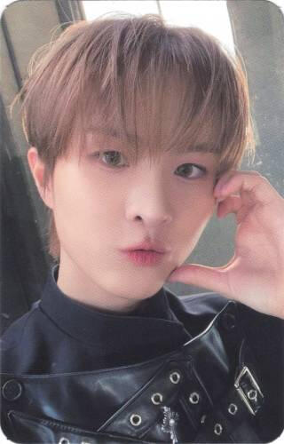 Photocard of Ivan making a cheek heart