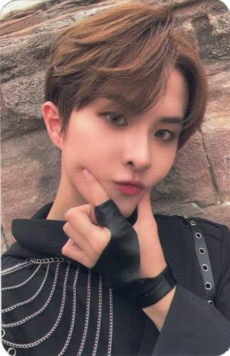 Photocard of Ivan wearing black and chains and pinching his cheeks