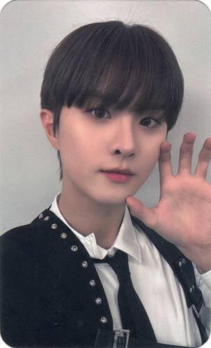 Photocard of Ivan wearing a studded suit and making a clawed hand