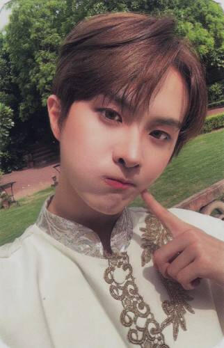 Photocard of Ivan poking his cheek