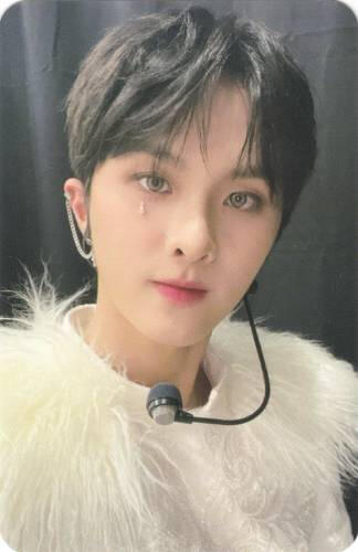 Photocard of Ivan wearing the white black crown outfit and looking at the camera