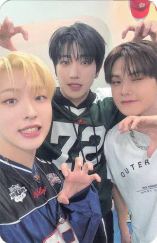 A photocard of Dann, Jahan, and Mujin making clawed hands