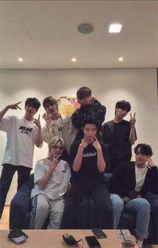 Photocard of Kingdom posing on a couch