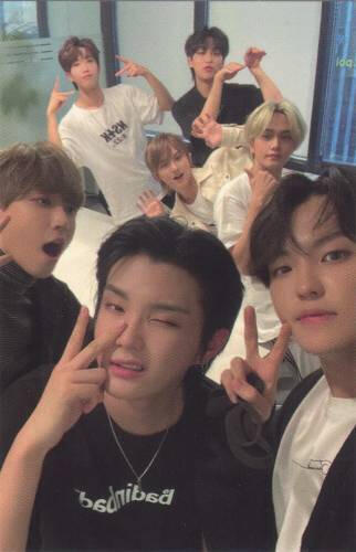 Photocard of the 7 Kingdom members, with Chiwoo, crowded in a room making various peace signs and poses