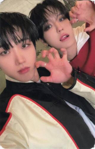 A photocard of Dann and Louis making clawed hands at the camera, Louis sticking his tongue out