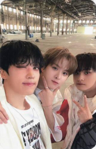 Photocard of Arthur, Ivan, and Jahan putting their arms on each others shoulders
