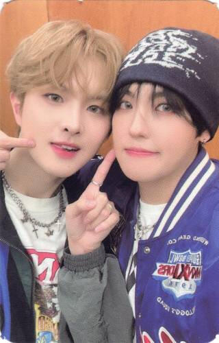 Photocard of Ivan and Louis poking their cheeks and smiling