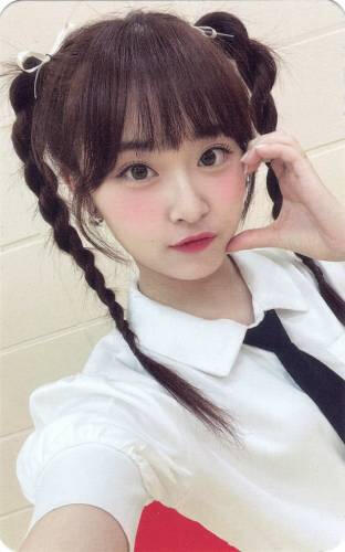 Photocard of Ririka from ILY:1 making a cheek heart