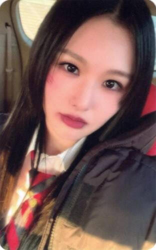 Photocard of a Craxy member wearing a black and yellow jacket and gazing into the camera
