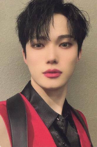 Photocard of Seungyeop from E'last wearing a black and red suit and staring into the camera