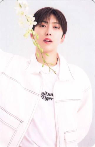 Photocard of Fuma standing with a white flower and slightly open mouth
