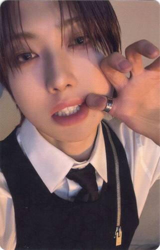 Photocard of Fuma pulling his lips to the side to expose his teeth