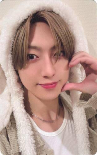 Photocard of Fuma wearing a fluffy hood and making a hand heart against his cheek