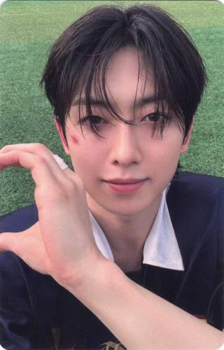 Photocard of Fuma making a hand heart to the edge of the card