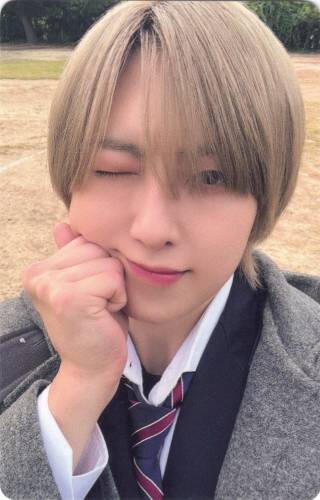 Photocard of Fuma squishing his fist against his cheek and winking