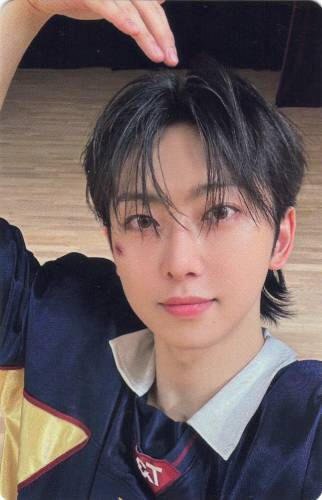 Photocard of Fuma dressed in a football uniform and making a heart with his arm over his head