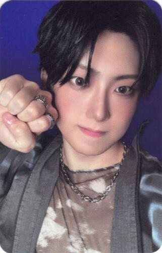Photocard of Fuma holding a fist by his cheek with a dorky face